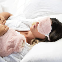 Plush and Cozy Hot Water Bottle | Soft Pink, on person with eye mask