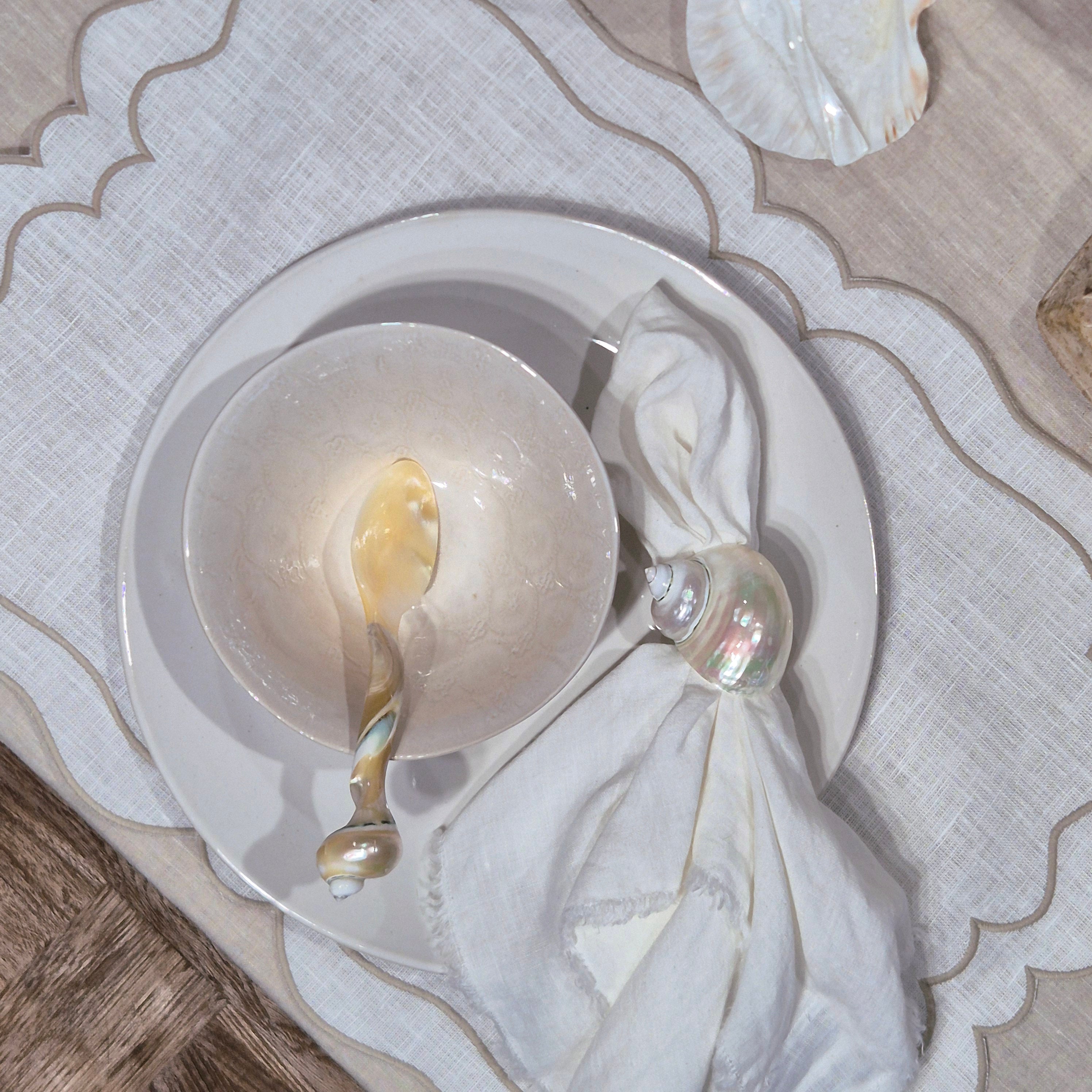 Decorative shell on a white dish with a textured surface