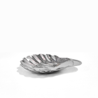 Silver shell-shaped dish on a white background