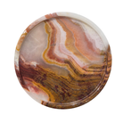 Round stone with multicolored patterns on a white background